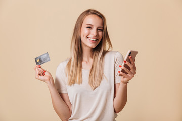 Portrait of a smiling casual girl holding mobile phone