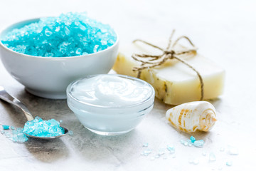 Fototapeta na wymiar Home cosmetic with cream and blue sea salt on stone background