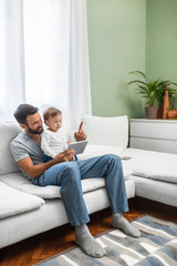 Father and Baby Looking at Tablet