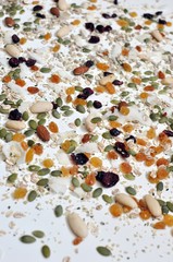 Randomized seeds and cereals on the white table, selective focus, close up view, vertical