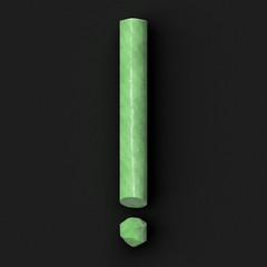 Green sidewalk or blackboard chalks assembled like pointing or punctuation mark of exclamation mark...