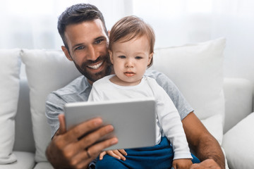 Father and Baby Looking at Tablet