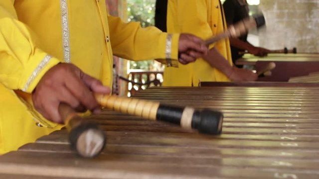 Asian Indonesian Balinese musician gamelan instrument. Closeup hands playing. Not edited, raw file.