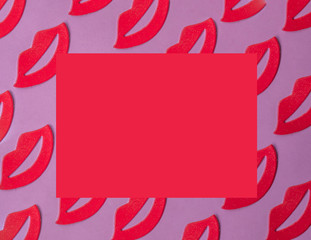 Red female lips pattern on pink background with copy space