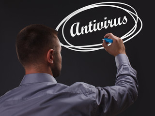 The concept of business, technology, the Internet and the network. Young businessman showing inscription: Antivirus