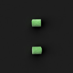 Green sidewalk or blackboard chalks assembled like mathematical operation division symbol on rough...