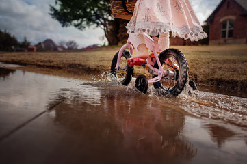 Young Girl in Dress Riding  Bike through Puddles, Barefoot, Clouds, Biking, Water