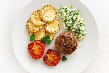 fried cutlet, marrow, and tomato, with fresh cucumber, green herbs, garlic  salad dressed with yogurt