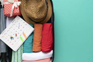 packing a luggage with calendar for a new journey and travel on green background