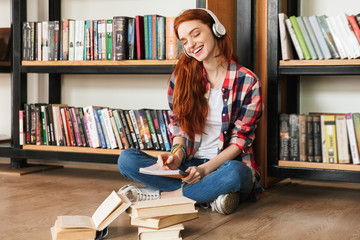 Smiling teenage girl doing homework