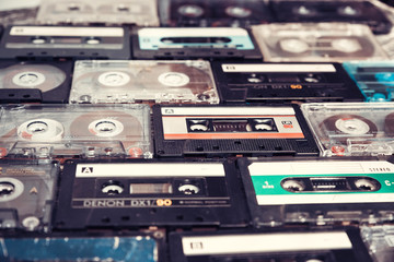 Vintage audio cassette on wooden background. Collection of a various retro audio tapes