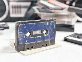 Vintage audio cassette on wooden background. Collection of a various retro audio tapes and tape recorder