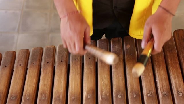 Asian Indonesian Balinese musician gamelan instrument. Closeup hands playing. Not edited, raw file.