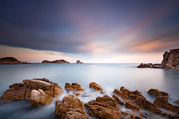 Beautiful landscape photo of amazing bay with sea rocks, sky clouds and soft water