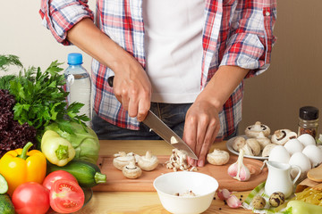 Woman cooks at the kitchen