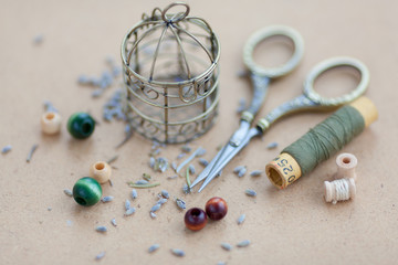 Vintage lifestyle with old threads, wooden beads, scissors and decorative bins