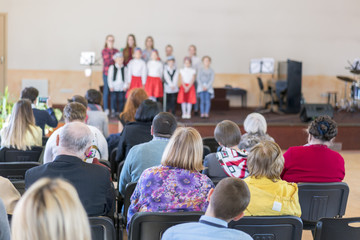 Children in kindergarten perform on stage. blurry
