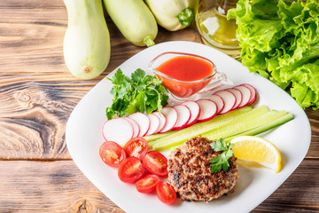 Chopped steak cutlet cooked on grill on white plate