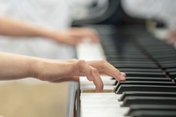 children's hands are playing the piano. Child's hand on piano keys