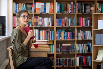 Young beautiful woman keep a book in her hand smiling
