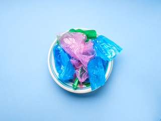 Colorful pastic bags in a dish texture closeup. Plastic use or disposal concept