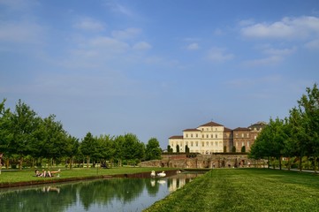 Fototapeta na wymiar Venaria reale, Piedmont region, Italy. June 2017. The landscape of the gardens of the royal palace of Venaria. Vision from the ruins of the temple of Diana towards the palace. Tourists.
