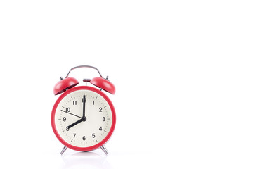 Classic retro red alarm clock isolated on a white background