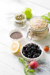 Bowl of assorted fresh colorful seasonal spring summer organic close up vegetables on white wooden shabby table background, healthy food clean eating concept, copy space