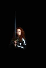 beautiful red haired woman warrior brandishing a broadsword