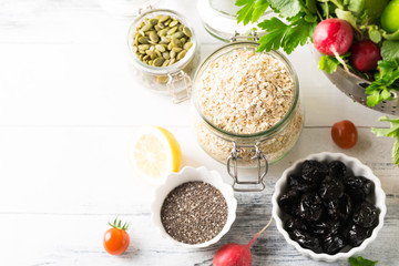 Bowl of assorted fresh colorful seasonal spring summer organic close up vegetables on white wooden shabby table background, healthy food clean eating concept, copy space