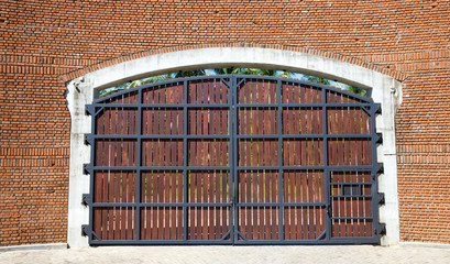Wooden gates with stone columns.