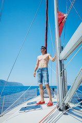 Young man sailing yacht