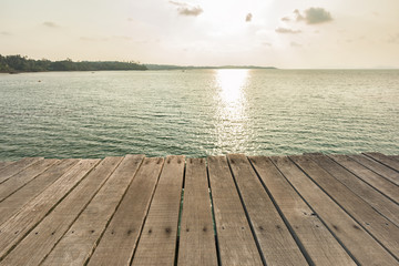 Fototapeta na wymiar Wooden floor with beautiful ocean and sunset sky.