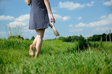 Woman barefoot walk in grass