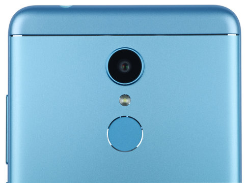 The back side of the modern smartphone close-up. Isolated on white background.