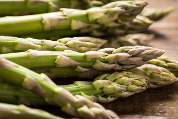 Green Asparagus in Juta Bag on White Wooden Table
