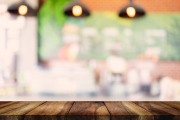 wood table with blurred interior in cafe background.