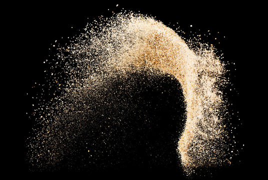 Sand flying explode on black background ,throwing freeze stop motion object design