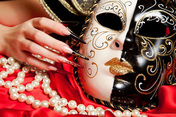 Fashionable nail design with mask on red background