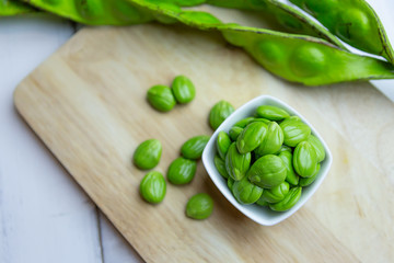 Petai, Bitter Beans on wood table, Thai vegetable food, Parkia speciosa seeds