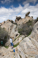 woman looking at the big rocks of capo dorso sardinia