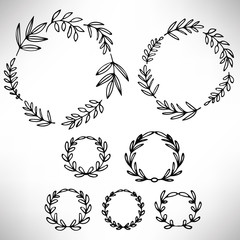 Set of hand drawn wreaths. Cute collection of floral design elements. Doodle branches. Round frame with plants and leaves isolated on white background. Vector illustration.