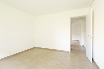 Fototapeta na wymiar Empty room in a modern apartment with white walls, nobody in the scene