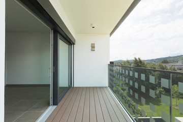 Balcony of new house with white walls, landscape view