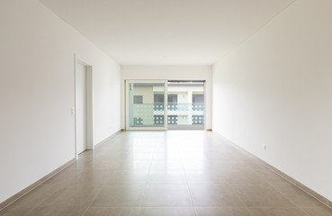 Empty room in a modern apartment with white walls, nobody in the scene