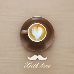 cup of coffee and white mustache over wooden background.