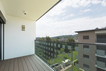 Balcony of new house with white walls, landscape view