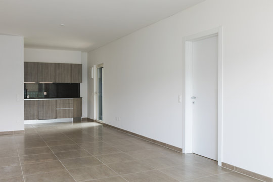 Interiors of modern apartment with white walls, kitchen