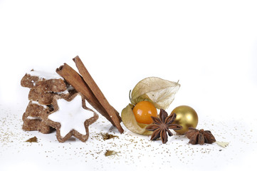 Biscuit in the cinnamon and the star anise with physalis in confetti on white background