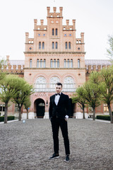 Fototapeta premium The handsome groom stands and waits for his bride